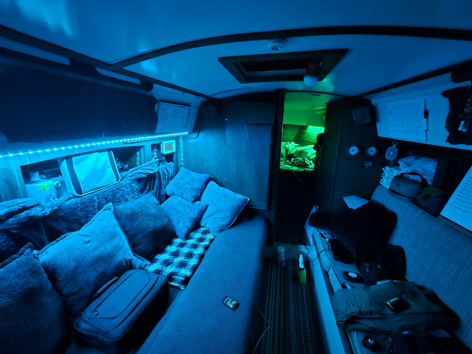 Photo of the cabin of Matilda, highlighting green and blue LED lights which light the space