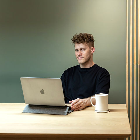 Tyson with laptop and coffee