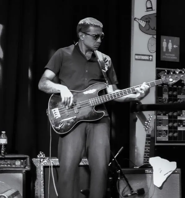 Man playing bass guitar, performing on stage with Honest Lee Soul- Presented by the New Haven Lounge Series.