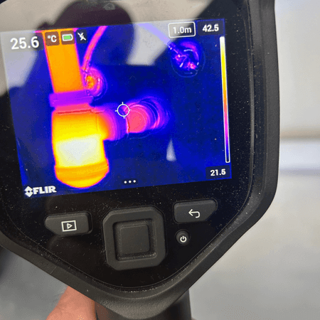 Thermal imaging used during a plumbing inspection in Portugal to identify temperature differences around plumbing pipework.
