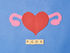 photo of paper heart, ovaries and letters PCOS