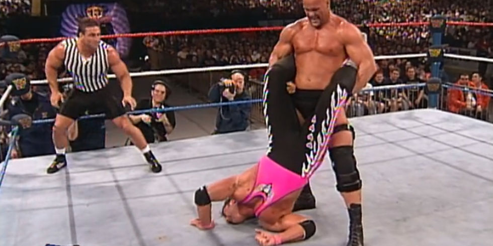 Stone Cold Steve Austin applies a Boston Crab to Bret The Hitman Hart during their Submission Match at WWF WrestleMania 13 while special guest referee Ken Shamrock looks on