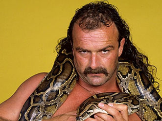 WWE pro wrestling legend Jake 'The Snake' Roberts posing for a picture with his snake Damien around his neck