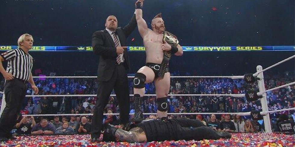 New WWE Champion Sheamus getting his hand raised by Triple H after cashing in Money in the Bank on Roman Reigns at Survivor Series 2015