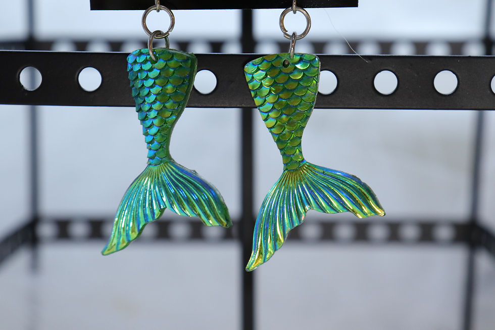 Handmade mermaid earrings in various colors.