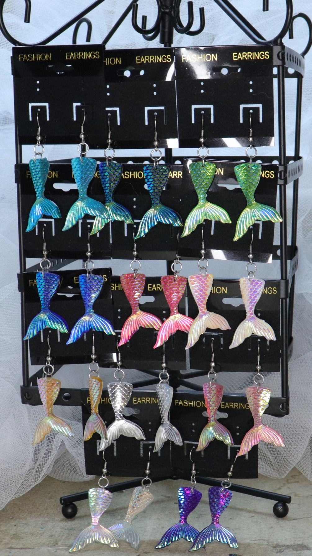 Handmade mermaid earrings in various colors.