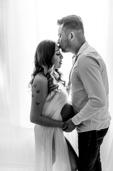 Luxurious Studio maternity session of beautiful expecting mother & spouse in our white sheer attire for a tender kiss moment Montgomery, IL Maternity, Newborn & cake smash Photographer | Alogs Photography
