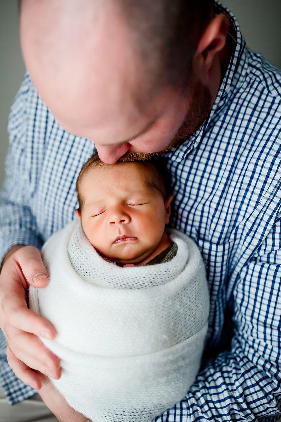 Wrapped newborn with safe and loose swaddling technique used by experienced Aurora IL newborn photographer