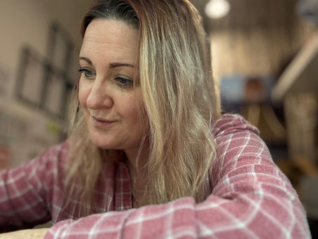 kelly writing blogs in her office