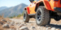 rear-wheel-orange-jeep-rocky-road.jpg