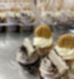 cupcakes with cookies on top on a table