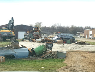 Tornado damage to a storage building at Central Fuel Injection. Clean up.