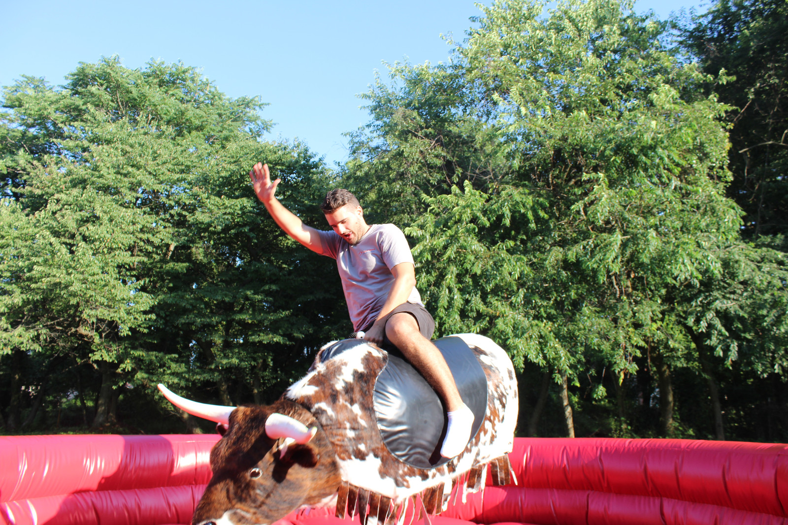 Man riding PBR Mechanical Bull from By the Horns Mechanical Bull Rental Delaware Pennsylvania Maryland