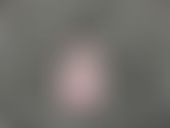 A crumpled queen of hearts playing card on a gravel sidewalk.