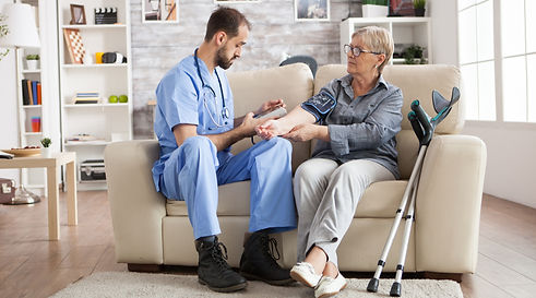 male-assistance-doing-blood-pressure-monitoring-senior-woman-nursing-home-sitting-couch-cr