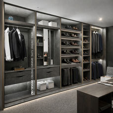 Premium bespoke built-in wardrobe installation by KV Designs Leeds, showcasing modern open dark grey cabinets with integrated hanging rails, custom open shoe shelving, trouser racks, and seamless under-shelf LED strip lighting.