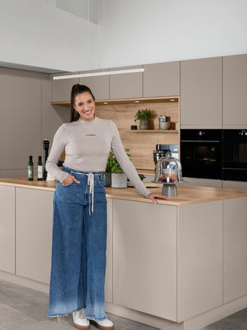 Modern bespoke fitted kitchen in taupe matte finish with a wooden worktop, designed and installed by KV Designs in Leeds.