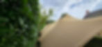 Beige stretch tent hire Devon set up in a lush garden