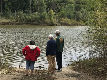 Vern Shroyer's children stand on the edge of the MIssissinewa Reservoir where it meets their father's home