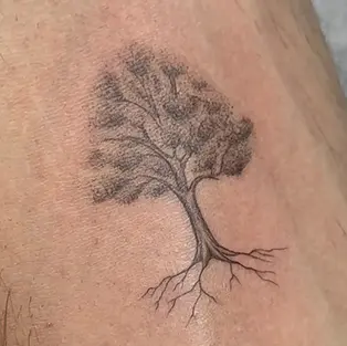 Fine line tree tattoo with detailed roots and black and grey shading by GG Tattoo Budva studio in Budva Montenegro