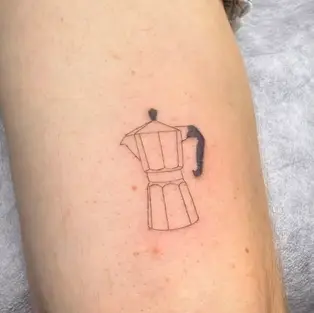 Minimalist fine line tattoo of a classic Italian moka pot coffee maker on lower leg