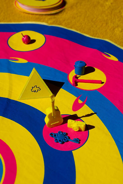 Yellow, Pink and Blue Circular Board Game with triangular dice