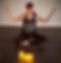 Woman in yoga pose with candles