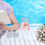 Thumbnail: Woman relaxing by pool, reading book, enjoying drink