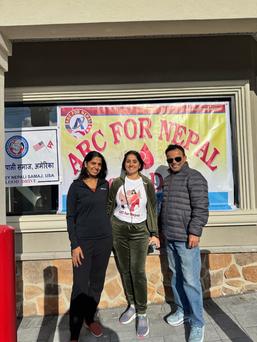 Group photo of people in front of a "ARC for Nepal" banner - highlighting their blood donation during the ARC for Nepal blood drive.