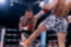 Fight photography example: Muay Thai fighter flexing in boxing ring