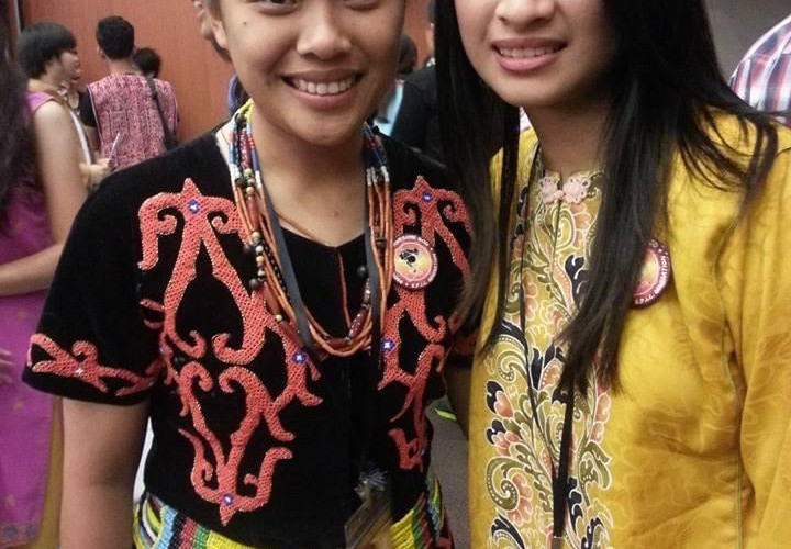 Kezia with her friends at a global conference with a different Lundayeh attire. As her father shared with her that the difference of her attire has something to do with her lineage.