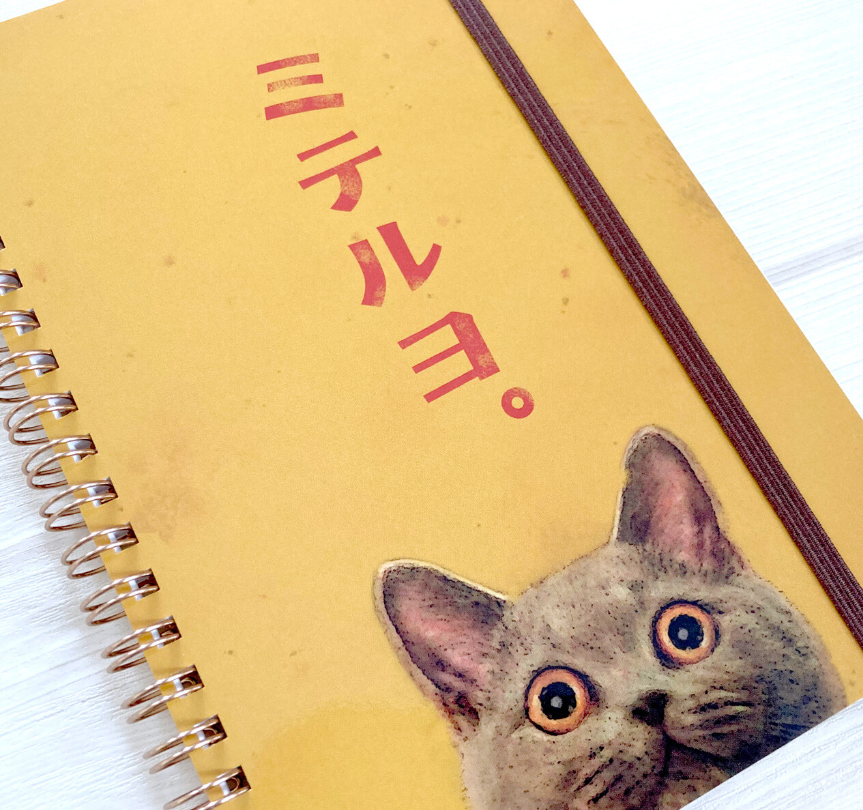 tokotoko circus spiral cat notepad, yellow notepad with cute cat and japanese writing on the front