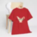 A red T-shirt hangs on a wooden chair, featuring a graphic of a gravy boat with the text "It's gravy, baby" in playful font.