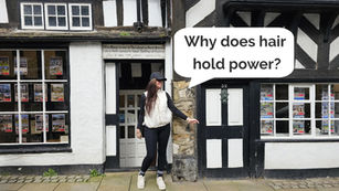 Woman in a cap stands outside a black-and-white Tudor house, with a speech bubble saying Why does hair hold power?