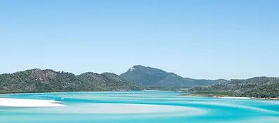 Aerial view of the Whitsundays showing white sand beaches and turquoise waters off the coast of Queensland, Australia.