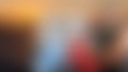 Man smiling at sunset beach with umbrellas, Greek and Turkish flags. Text: "Bodrum > Kos Itinerary (& Birthday Getaway)".