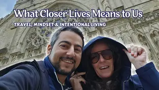 A couple smiling together outdoors while exploring ancient architecture during their travels, embodying intentional living and slow travel with Closer Lives.