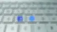 Close-up of a keyboard with specific keys featuring the Facebook and Messenger logos.