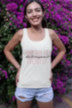 A person is wearing a white tank top with the words "WEAR IT don't compare it" printed on the front in bold letters.