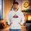 Thumbnail: Man wearing white hoodie with text and Christmas tree in the background.