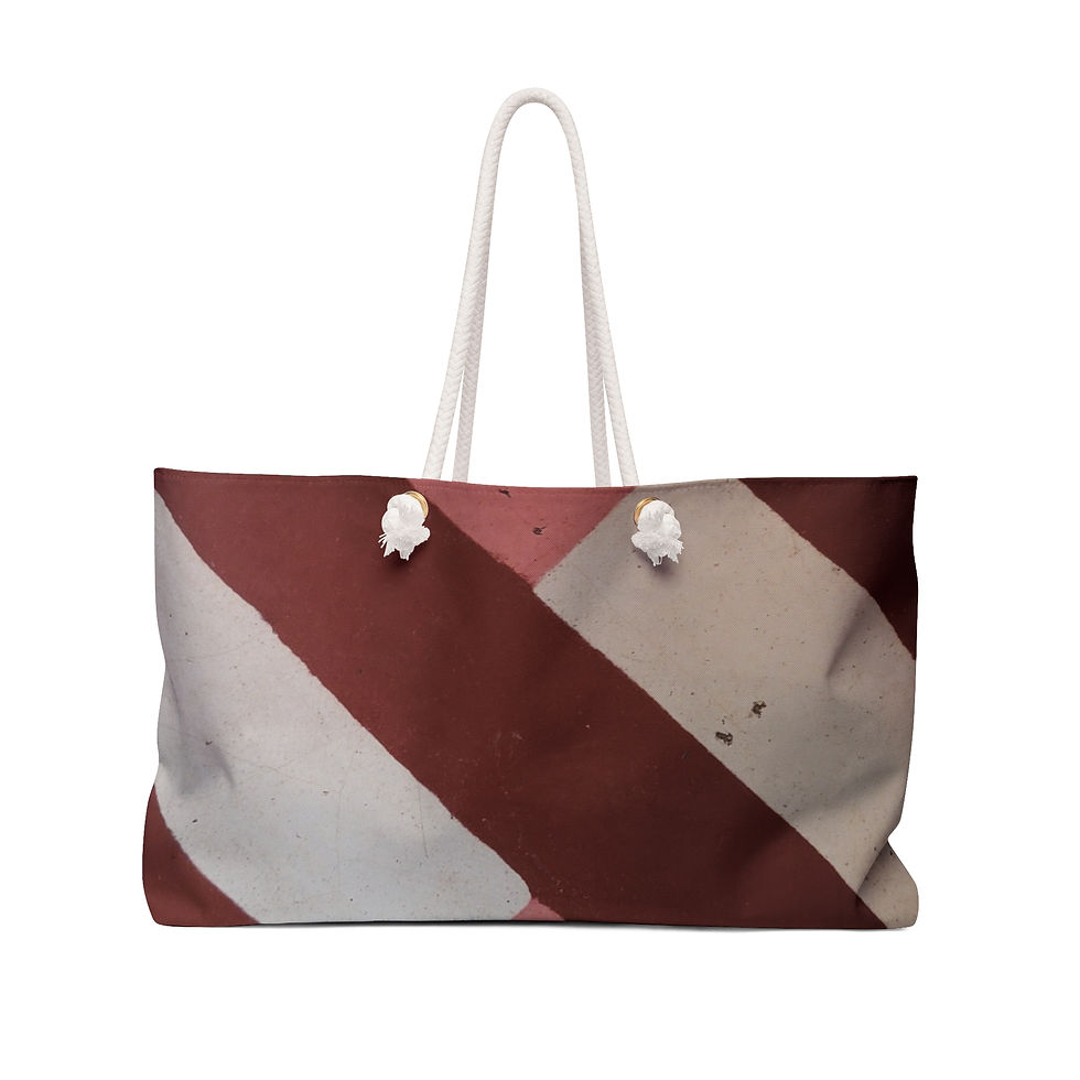 A large weekend tote bag with red and white diagonal stripes and white rope handles, reminiscent of vibrant Mexican Tile Art.
