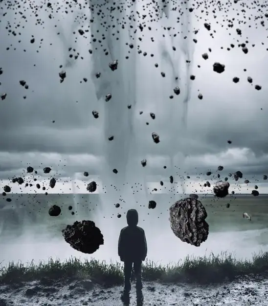 Silhouette of a person in a hoodie facing a stormy sky with debris swirling around. Dark clouds in the background create a dramatic mood.