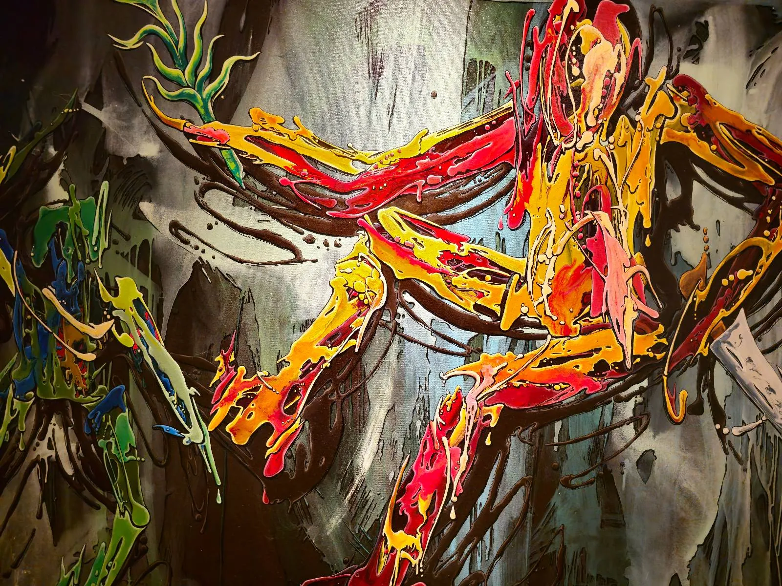 Abstract painting featuring vibrant, swirling streaks of red, yellow, orange, and green, forming dynamic, human-like figures against a dark, textured background. The scene appears energetic and expressive.