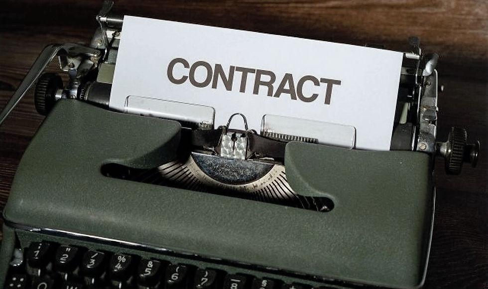 A typewriter holds a sheet of paper with the word "CONTRACT" typed on it.