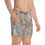 Thumbnail: A man stands with one hand in his pocket, donning the Crystal Rock Swim Trunks from the Mexican Tile Style Collection.