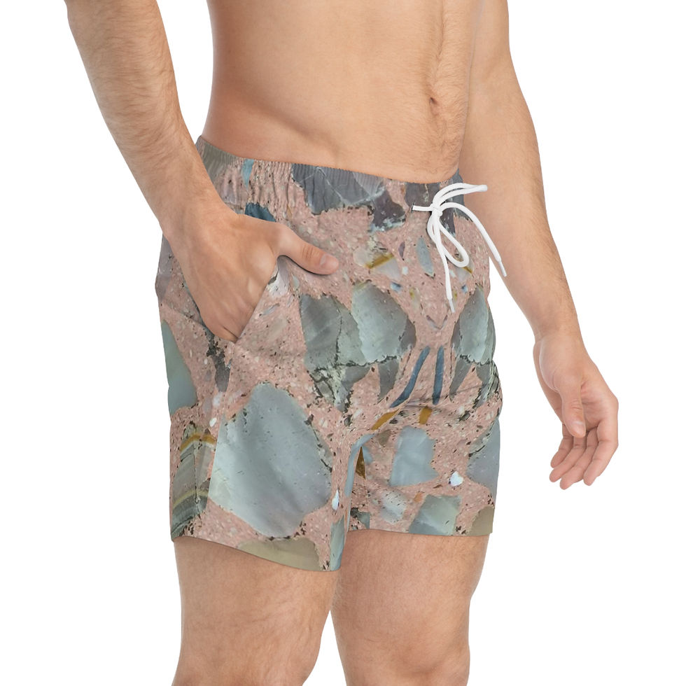 A man stands with one hand in his pocket, donning the Crystal Rock Swim Trunks from the Mexican Tile Style Collection.