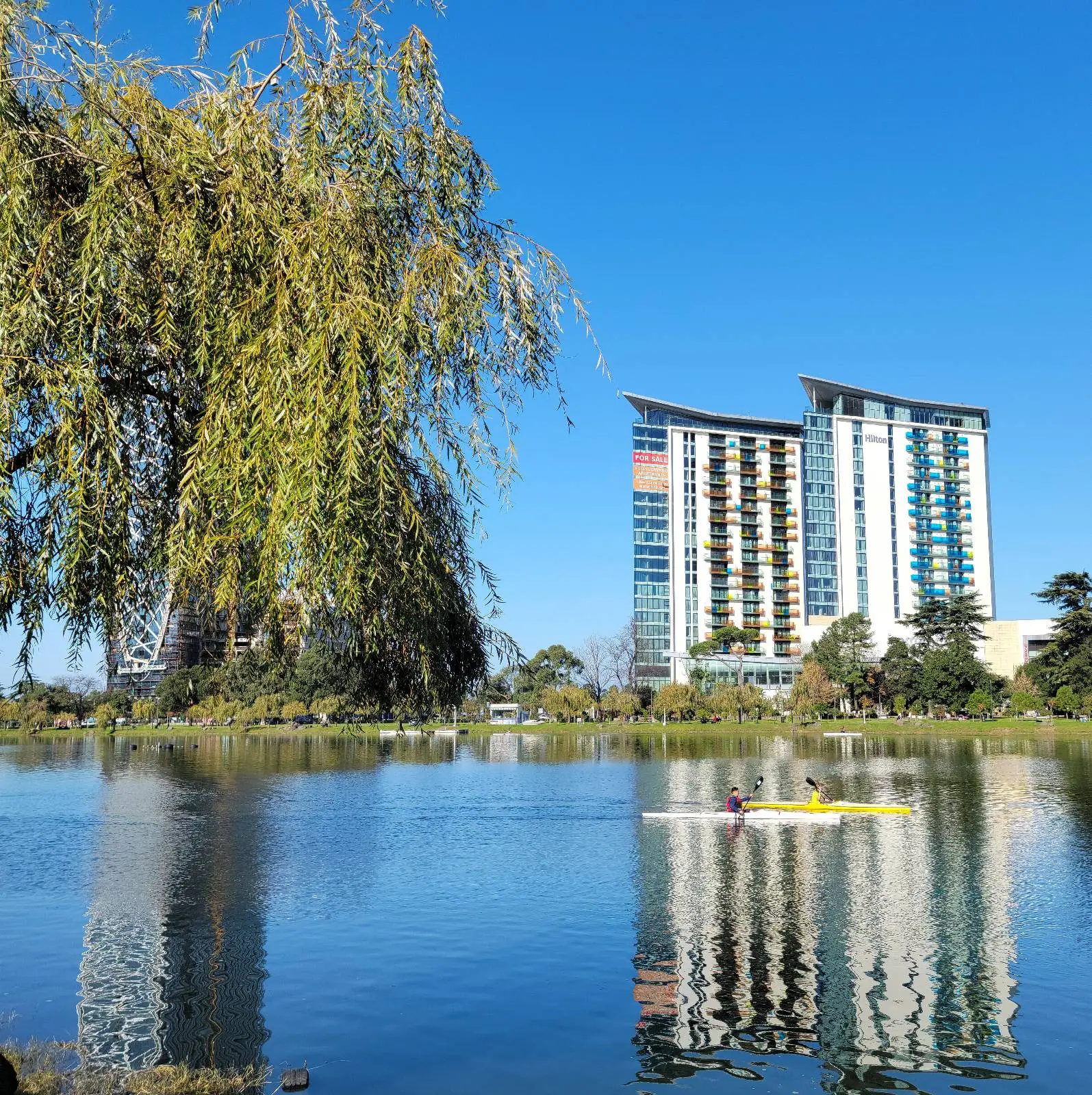 Lake on the boulevard of Batumi, reflecting two skyscrapers just to the rear of the view.