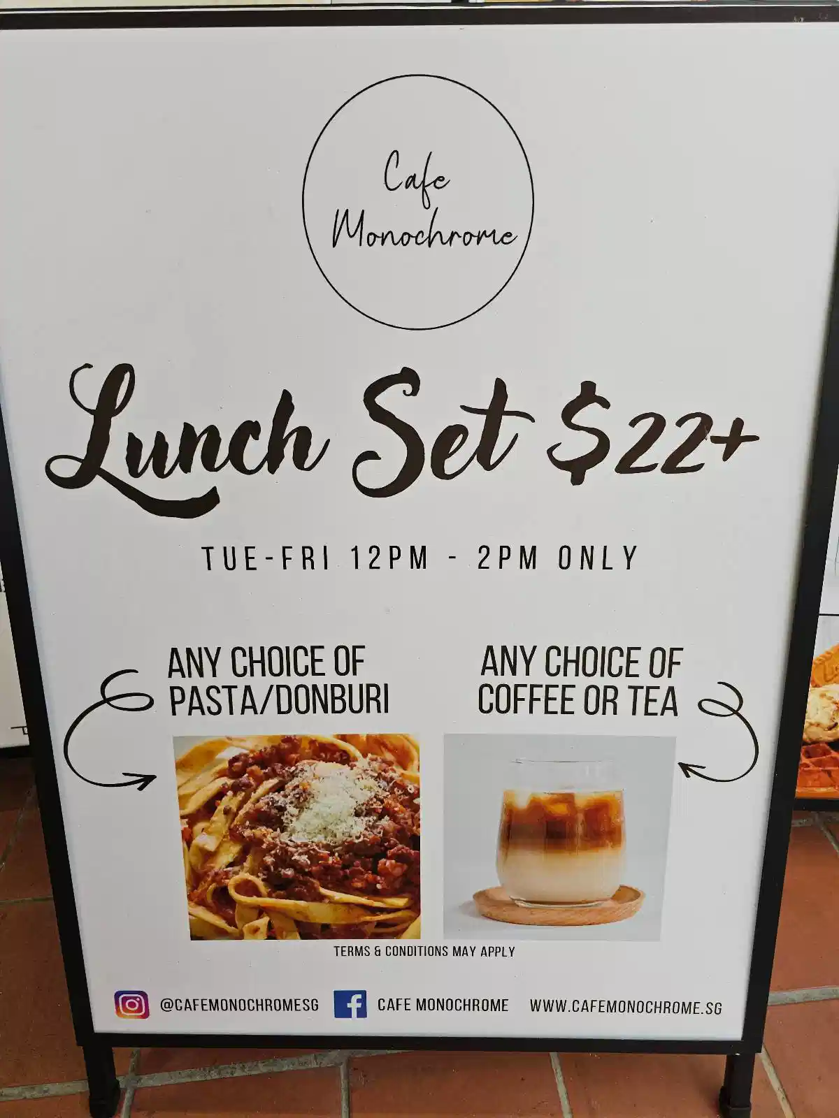 A cafe sign advertises a lunch set for $22+, available Tuesday to Friday from 12 PM to 2 PM, featuring a choice of pasta or donburi and a choice of coffee or tea.