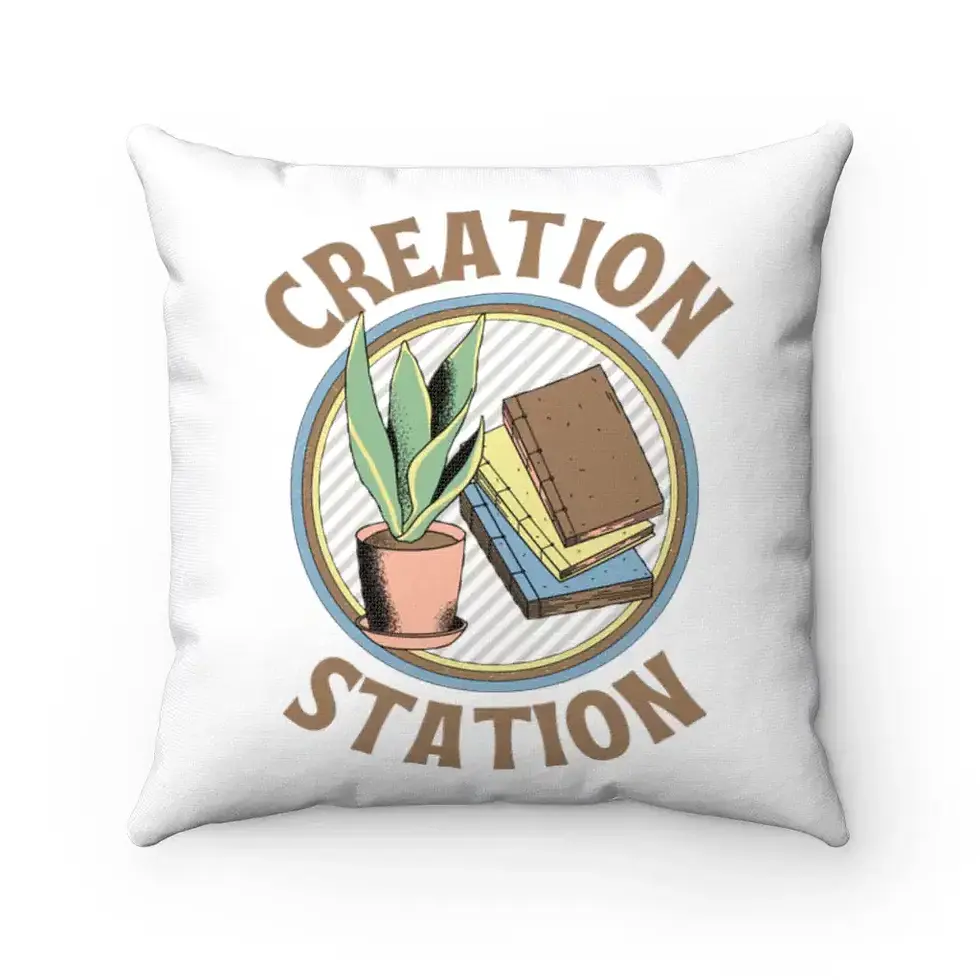 A white pillow features a circular design with a potted plant and two books, accompanied by the words "Creation Station".