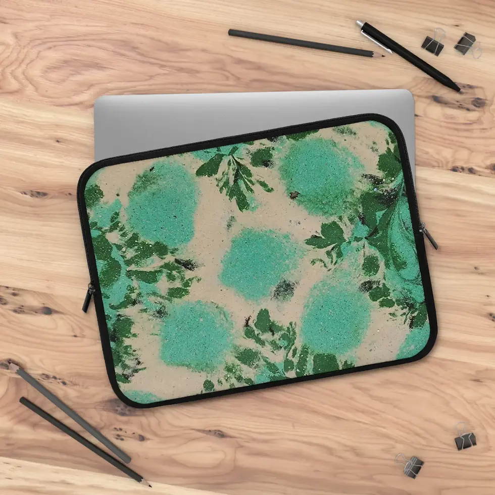 Green, teal, and beige floral laptop case from the Mexican Tile Style collection on wooden desk.